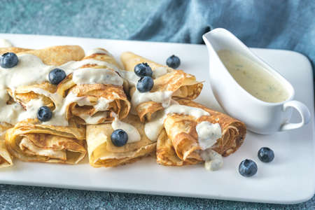 Crepes with blue cheese sauce decorated with fresh blueberriesの写真素材