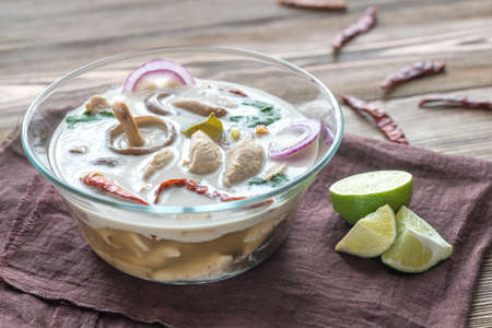 Glass bowl of thai tom kha kai soupの写真素材