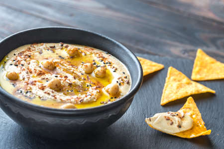 Bowl of hummus with tortilla chips