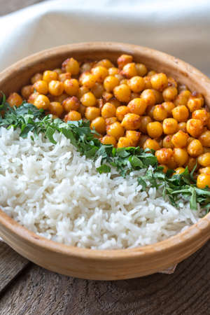 Bowl of chickpea curry with white rice and fresh cilantroの写真素材