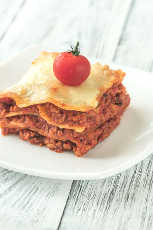 Portion of lasagne on the white plateの写真素材