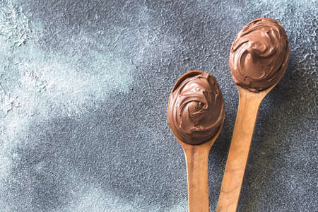 Two wooden spoons of chocolate creamの写真素材