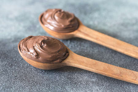 Two wooden spoons of chocolate creamの写真素材