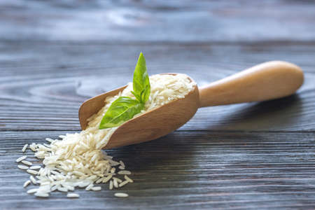 Scoop of uncooked basmati riceの写真素材