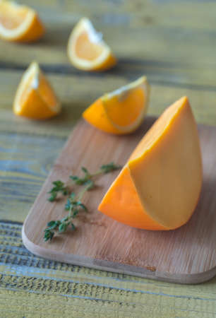 Mimolette cheese on the wooden boardの写真素材