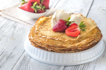Crepes with cream cheese and fresh strawberriesの写真素材