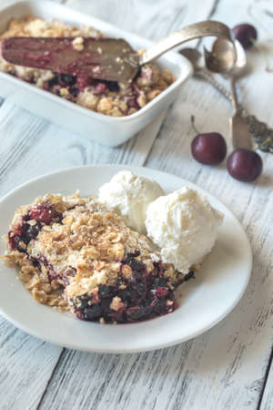 Portion of berry crumble with vanilla ice creamの写真素材
