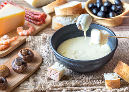 Bowl of fondue with appetizersの写真素材