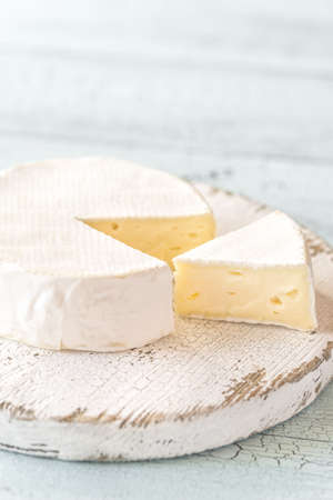 Camembert with capers on the wooden board