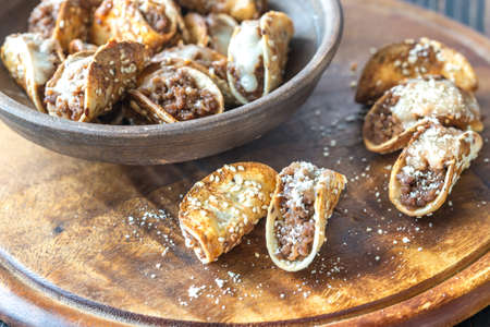 Mini tacos with ground beef, mozzarella and parmesan
