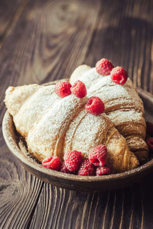Croissants with fresh raspberriesの写真素材
