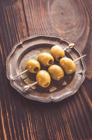 Olive skewer on the vintage plateの写真素材