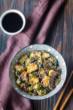 Bowl of roasted brussels sprouts with teriyaki sauceの写真素材