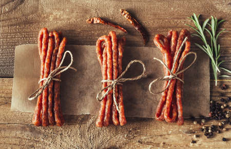 Kabanosy sausages with spices on the wooden backgroundの写真素材