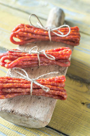 Kabanosy sausages on the wooden background