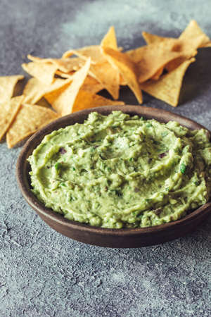 Guacamole in bowl with tortilla chips
