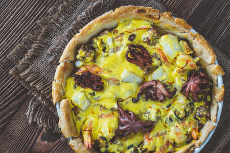 Pie with seafood and saffron cream sauce