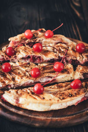 Cherry custard pie decorated with cocktail cherriesの写真素材