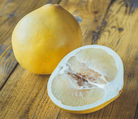 Pomelo on the wooden table: cross sectionの写真素材