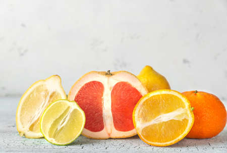 Variety of citrus fruit on the wooden background