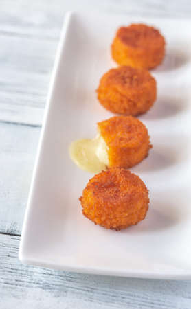 Camembert nuggets on the white plate