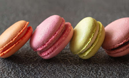Colorful macarons on the dark  background