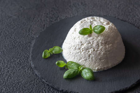 Ricotta - Italian whey cheese with fresh basil leaves