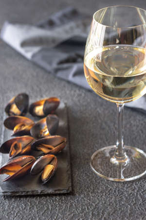 Mussels with a glass of white wine on the darkの写真素材