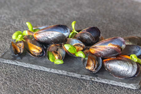 Cooked mussels on the slate boardの写真素材