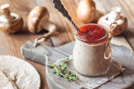 Mushroom pate decorated with with fresh thyme in the glass jarの写真素材