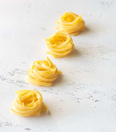 Raw fettuccine on the white background