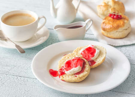 Classic scones with cream and red currant jamの写真素材