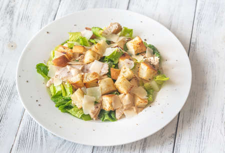 Portion of Caesar salad on the wooden tableの写真素材