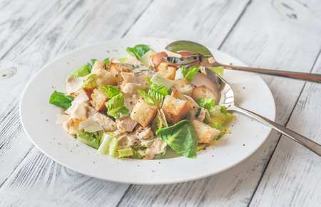 Portion of Caesar salad on the wooden tableの写真素材