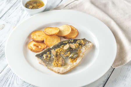 Baked sea bass with capers and fried potatoes