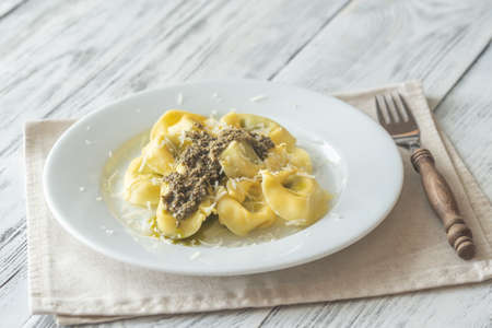 Portion of tortelloni stuffed with ricotta with pestoの写真素材