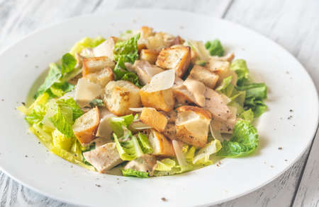 Portion of Caesar salad on the wooden tableの写真素材