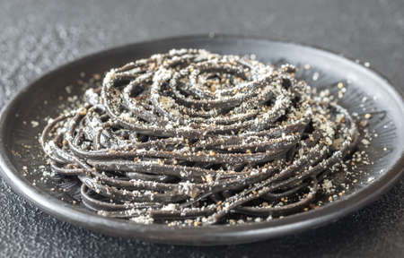 Portion of Cacio e pepe pasta with wheat germ and black squid inkの写真素材