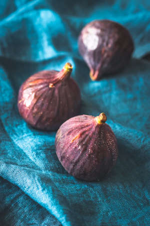 Three fresh figs on the blue linen napkinの写真素材