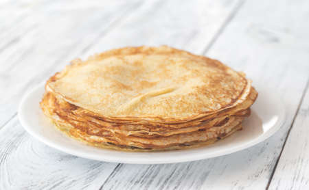 Stack of homemade crepes on the white plate