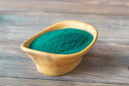 Bowl of spirulina on the wooden tableの写真素材