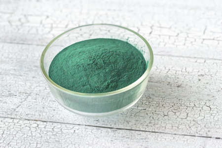 Bowl of spirulina on the wooden tableの写真素材
