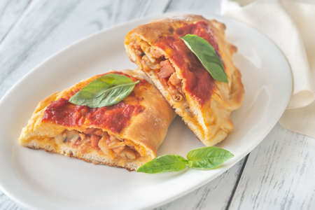 Homemade calzone stuffed with pancetta and mushrooms: cross sectionの写真素材