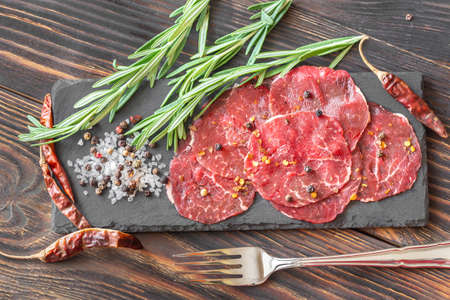 Carpaccio - slices of raw beef on the stone boardの写真素材
