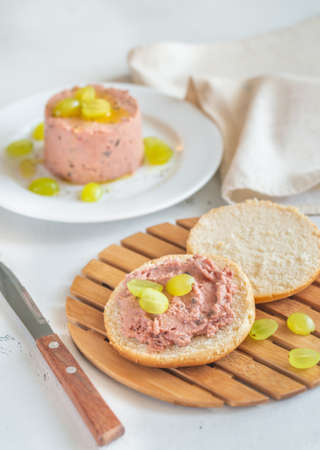Slice of bread with pate with glass of wine on the wooden board