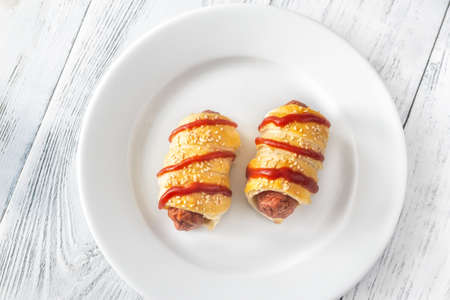 Sausage rolls on the white plate: top viewの写真素材