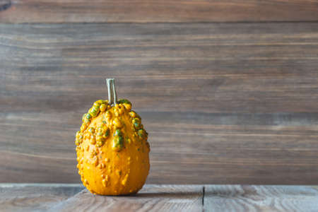 Ornamental pumpkin on the wooden backgroundの写真素材
