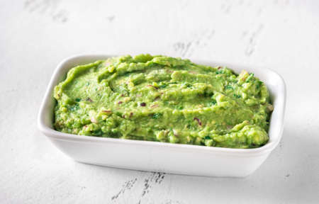 Bowl of guacamole on whiteの写真素材