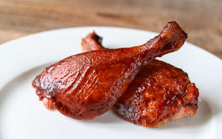 Barbecue duck legs served on white plateの写真素材