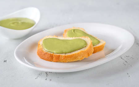 Slices of baguette with pistachio butterの写真素材